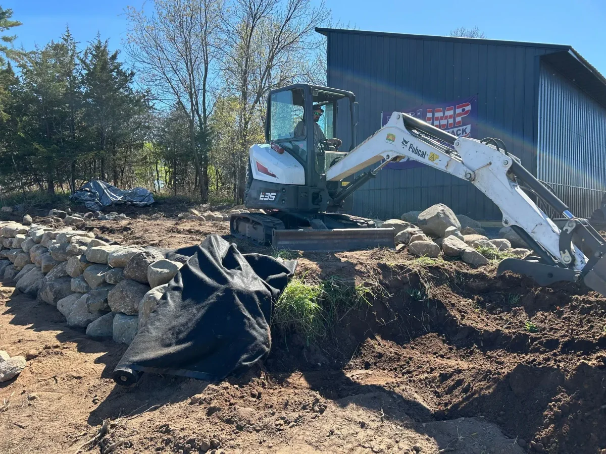 Professional landscaping crew and equipment ready for outdoor projects, showcasing tools and materials used in landscape renovation and irrigation installation.