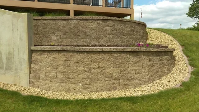 Curved stone retaining wall with gravel edging and planting shelf